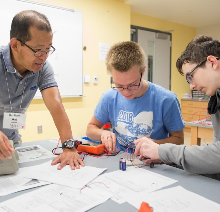 Students working with their professor