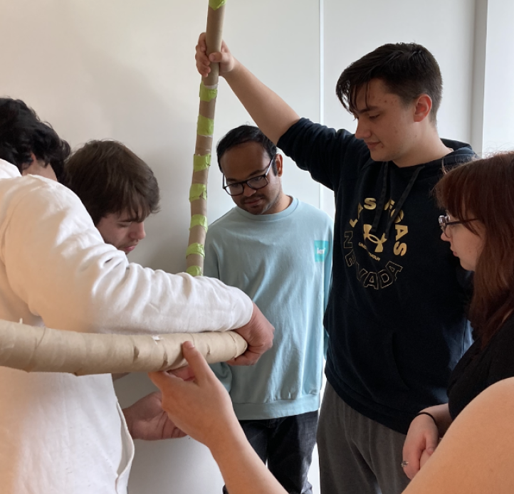 Students making rollercoaster with paper towel rolls