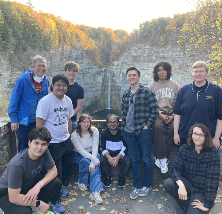 Happy students in front of waterfall